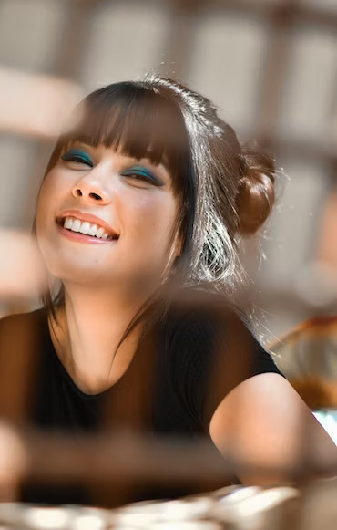 woman with blue eye shadow and beautiful teeth smiling