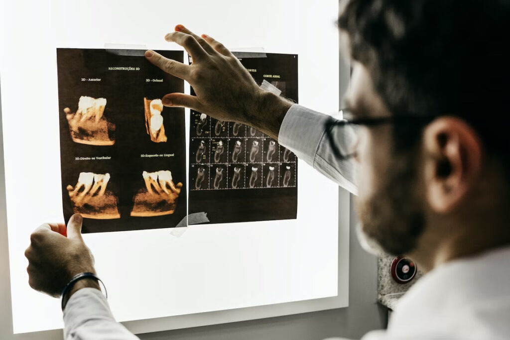 a dentist examining a dental x-ray