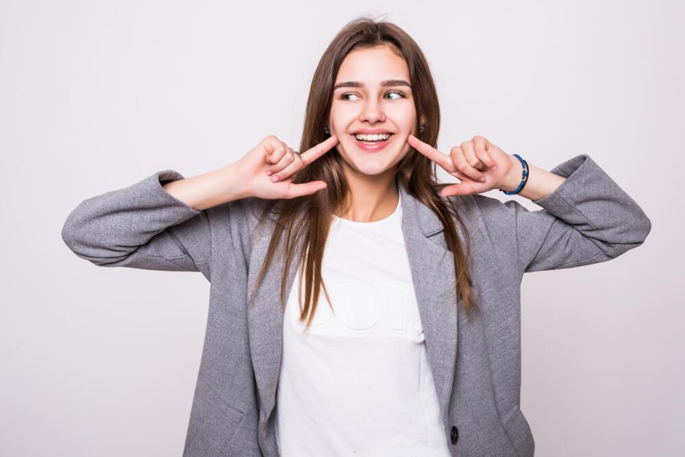 a woman showing off her beautiful smile