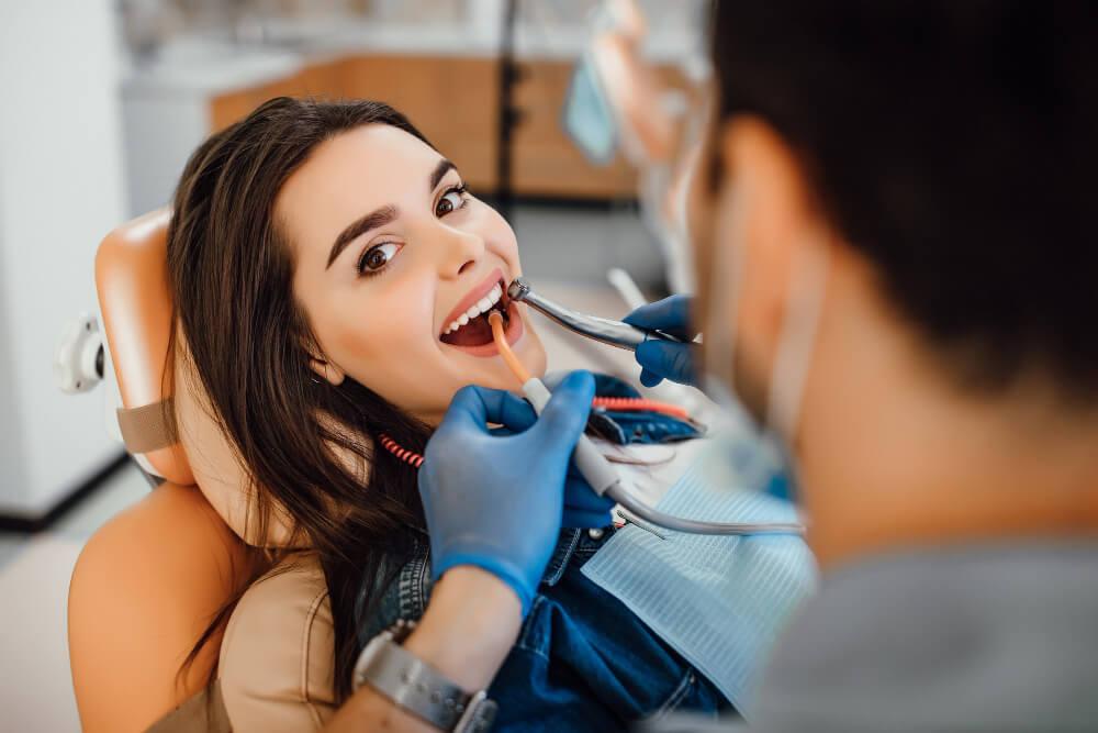 a woman smiling during a dental procedure